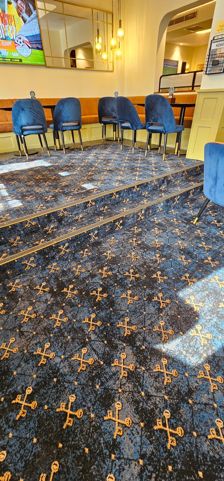 Carpet installed to tiered steps and landing with brass nosings at Cross Keys Hotel