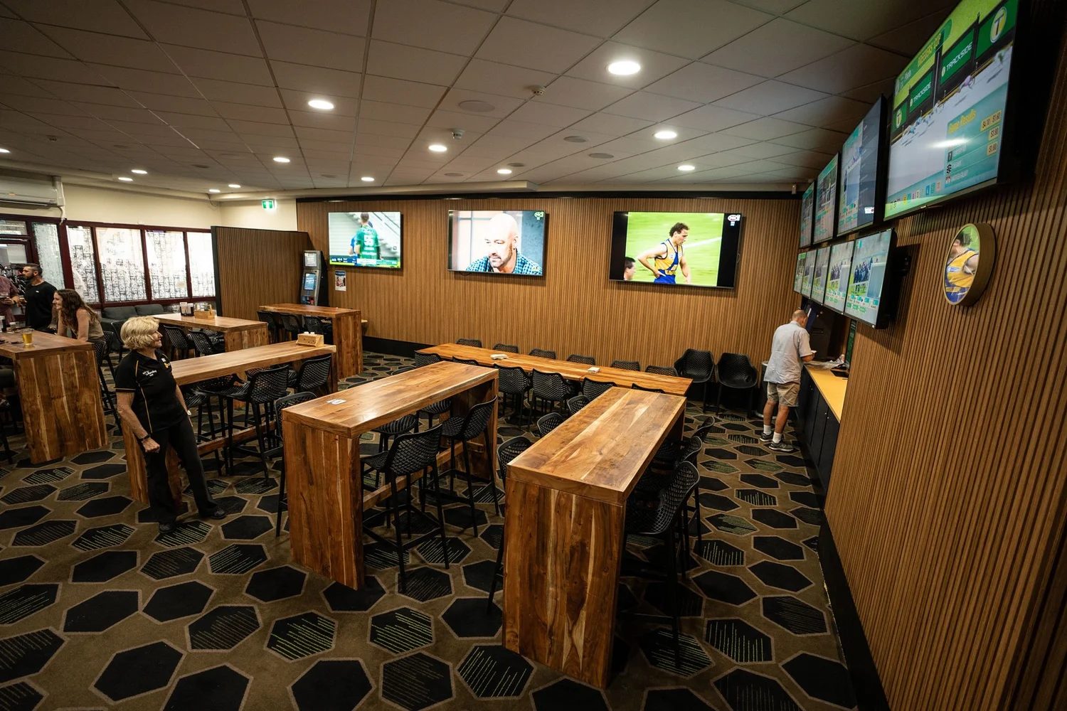 Sports bar at Pacific Palms Recreation Club with custom designed hexagon pattern axminster carpet installed by First Track Flooring